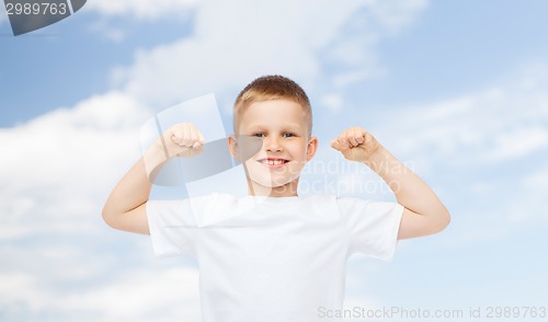 Image of happy little boy in white t-shirt flexing biceps