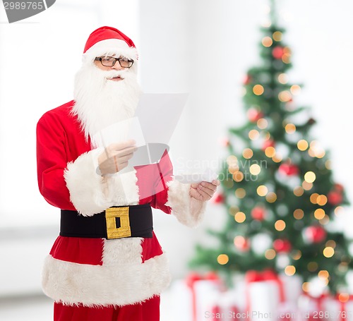 Image of man in costume of santa claus with letter