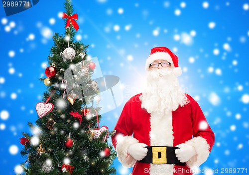 Image of man in costume of santa claus with christmas tree