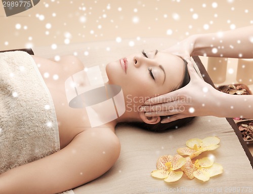 Image of beautiful woman getting face or head massage