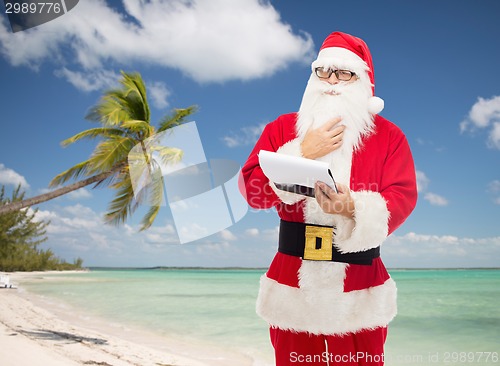 Image of man in costume of santa claus with notepad