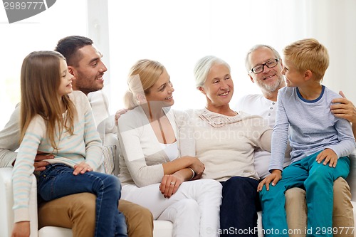 Image of happy family sitting on couch at home