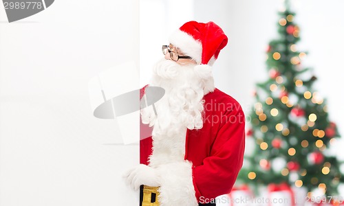 Image of man in costume of santa claus with billboard