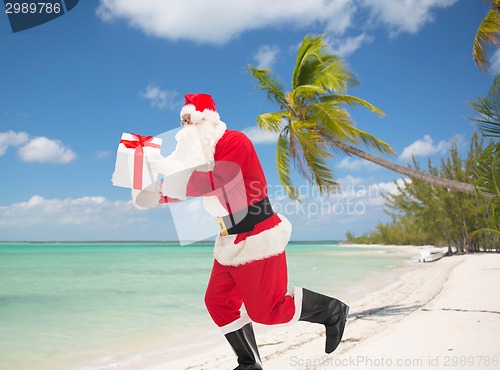 Image of man in costume of santa claus with gift box