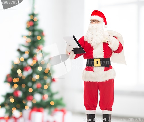 Image of man in costume of santa claus with notepad and bag