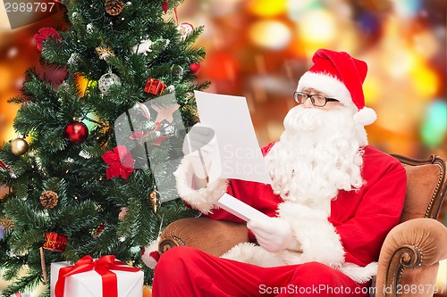 Image of man in costume of santa claus with letter