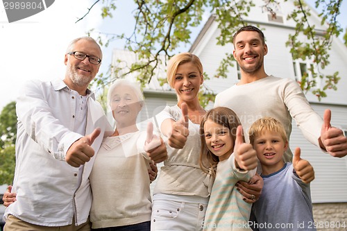 Image of happy family in front of house outdoors