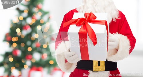 Image of man in costume of santa claus with gift box