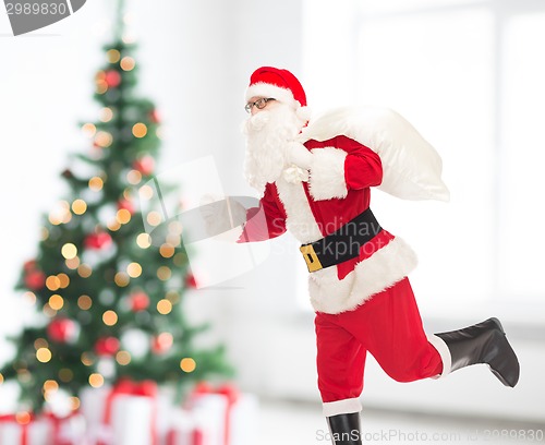 Image of man in costume of santa claus with bag