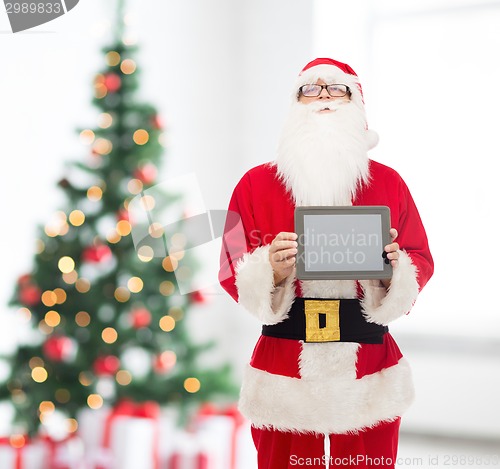 Image of man in costume of santa claus with tablet pc