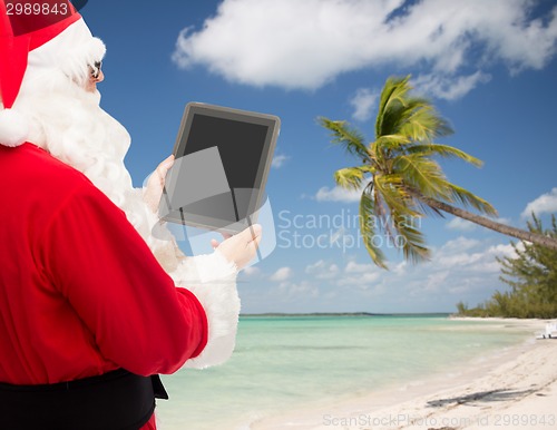 Image of man in costume of santa claus with tablet pc