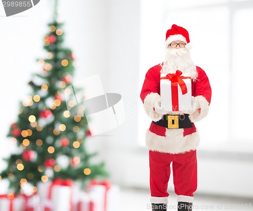 Image of man in costume of santa claus with gift box