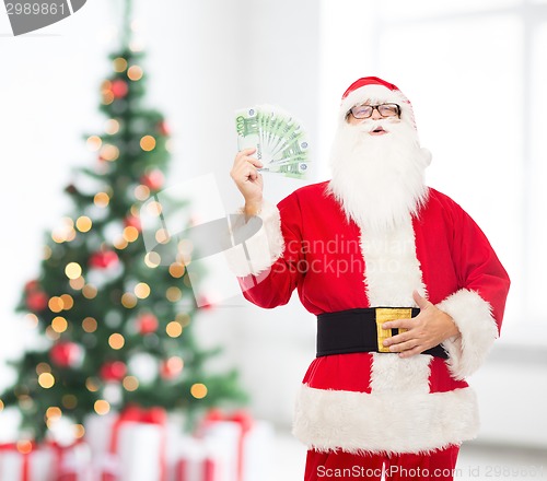 Image of man in costume of santa claus with euro money