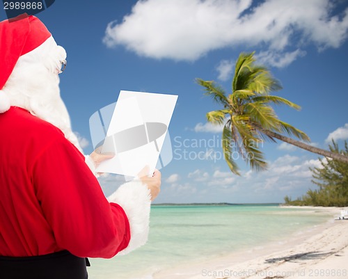 Image of man in costume of santa claus with letter