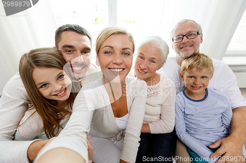 Image of happy family making selfie at home