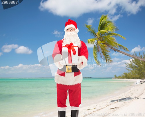 Image of man in costume of santa claus with gift box