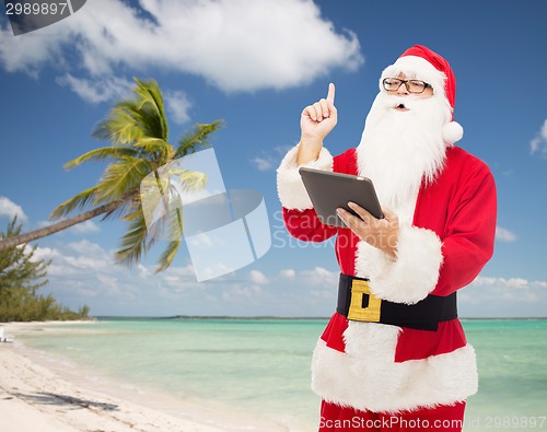 Image of man in costume of santa claus with tablet pc