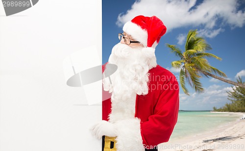 Image of man in costume of santa claus with billboard