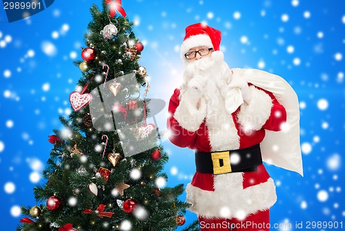 Image of santa claus with bag and christmas tree