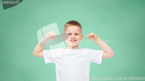 Image of happy little boy in white t-shirt flexing biceps