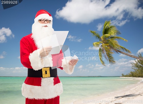 Image of man in costume of santa claus with letter