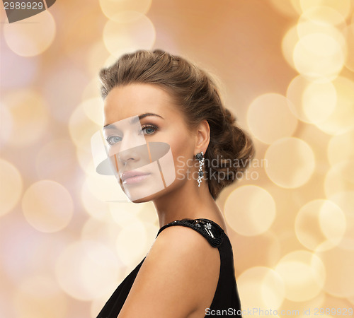 Image of beautiful woman in evening dress wearing earrings