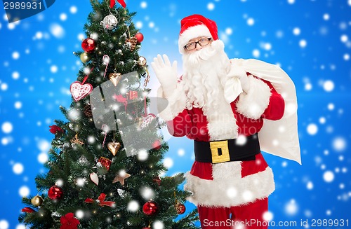 Image of santa claus with bag and christmas tree