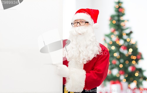 Image of man in costume of santa claus with billboard