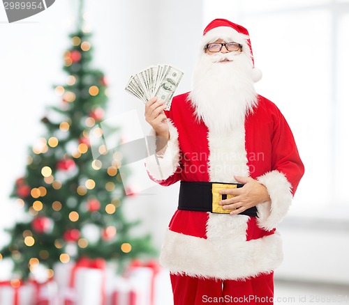 Image of man in costume of santa claus with dollar money