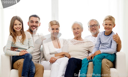 Image of happy family sitting on couch at home