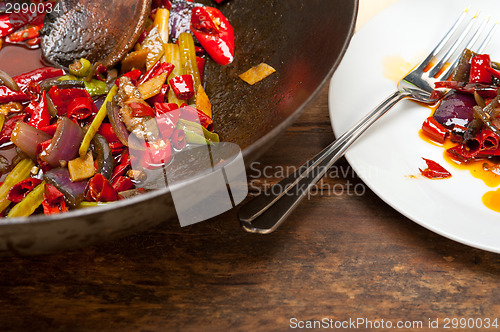 Image of fried chili pepper and vegetable on a wok pan