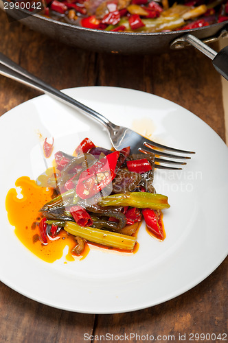 Image of fried chili pepper and vegetable on a wok pan