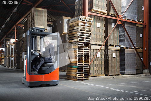 Image of Reach truck driver in a warehouse