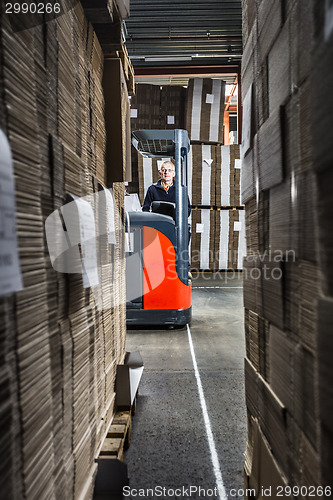Image of middle aged reach truck driver