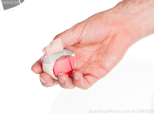 Image of Male hand with a red and white ball