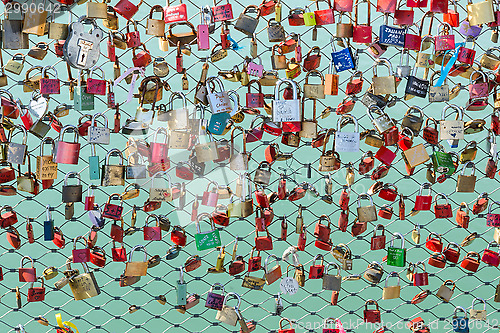 Image of Padlocks hanging on the bridge over the river