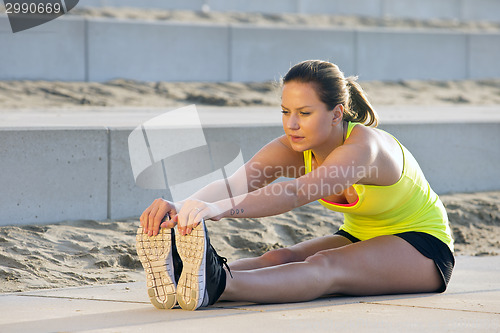 Image of Woman stretching and touching her toes