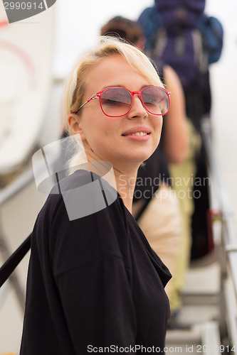 Image of Woman boarding airplane.