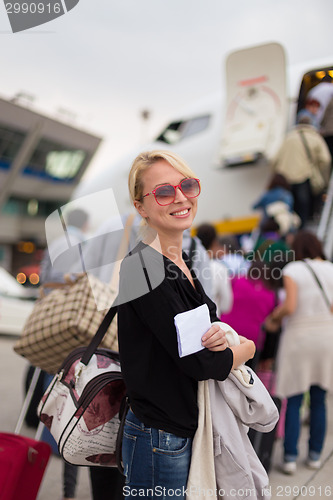 Image of Woman boarding airplane.