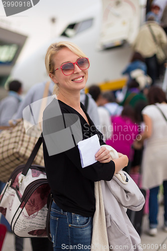 Image of Woman boarding airplane.