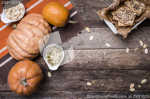 Image of Pumpkins with cookies and seeds on wood in Rustic style 