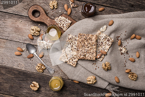 Image of Cookies with seeds, nuts, honey on wooden table