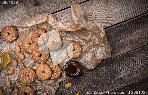 Image of Nuts and Cookies on paper and wooden table
