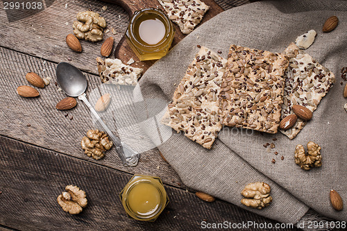 Image of Cookies with seeds,  honey on napkin and wooden table