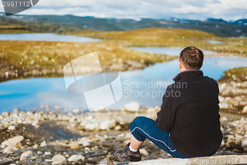 Image of Man Sitting On Stone In Norwegian Mountains