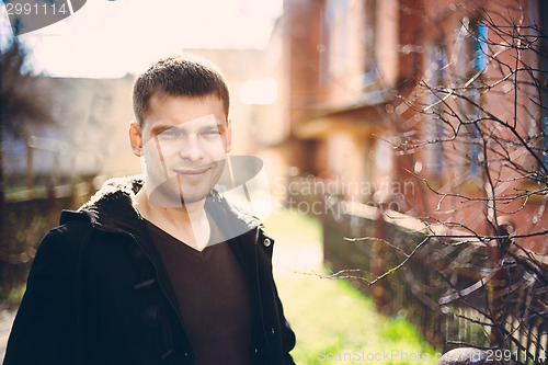 Image of Young Handsome Man Staying Near Old Wooden House In Autumn Or Sp