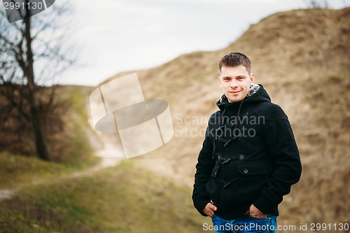 Image of Young Handsome Man Stayed In Field, Meadow In Autumn Day