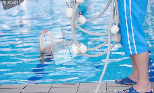 Image of help and rescue on swimming pool