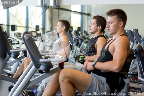 Image of men working out on exercise bike in gym