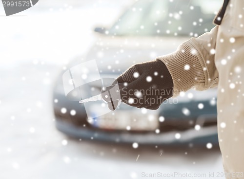 Image of close up of man with car key outdoors